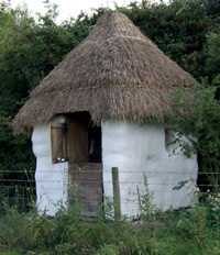 straw bale compost toilet with thatched roof